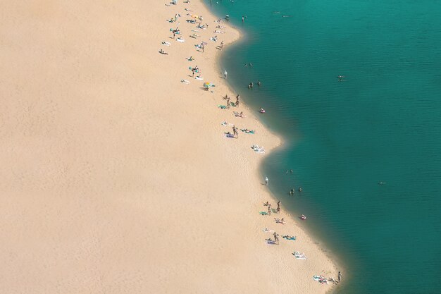 Top view of the sea and the beach with people.