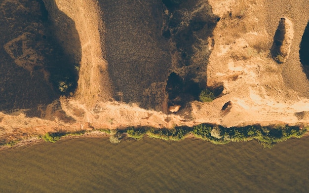 Top view of the sea coast with soil erosion