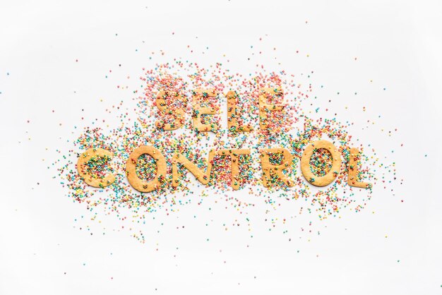 Top view of self control lettering made from sweets isolated on white healthy living concept