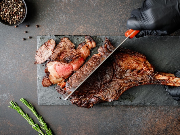 Top view of serving grilled dryaged marble beef steak Tomahawk with spices Flat lay cooking concept