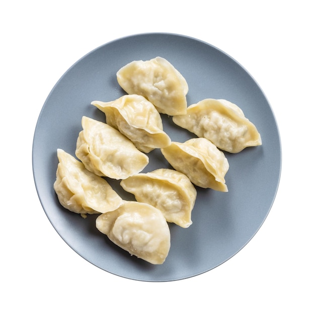 Top view of several boiled dumplings on gray plate