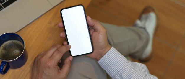 Top view shot of hand holding smartphone