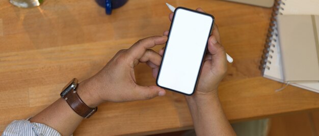 Top view shot of hand holding smartphone