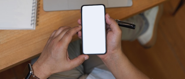 Top view shot of hand holding smartphone