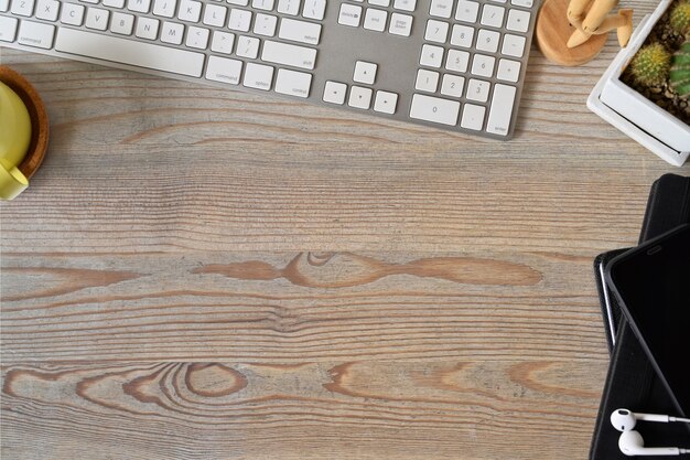 Top view shot of office wooden table top with office accessories and copy space.