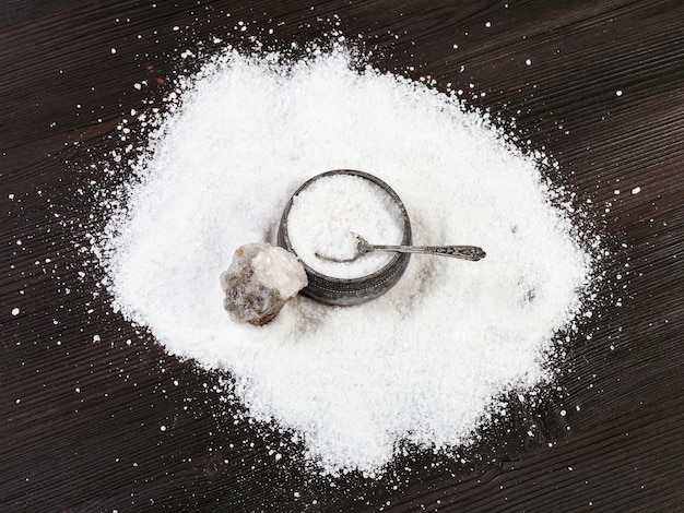 Top view of silver salt cellar and raw Halite