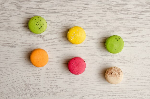 Top view of six multi colored macarons