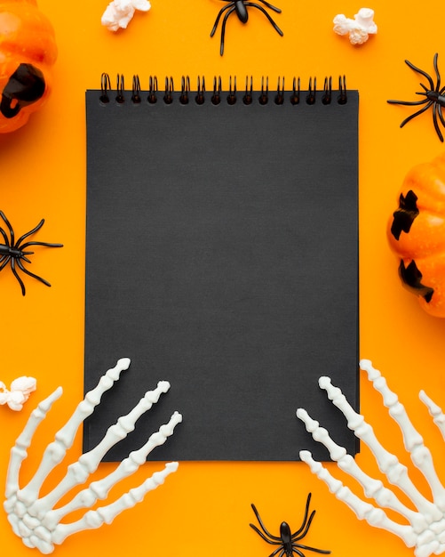 Top view skeleton hands on notepad for halloween