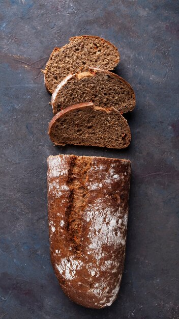 Top view of sliced bread on dark surface. Closeup