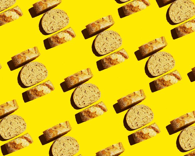 Top view of sliced bread on a yellow background Food pattern