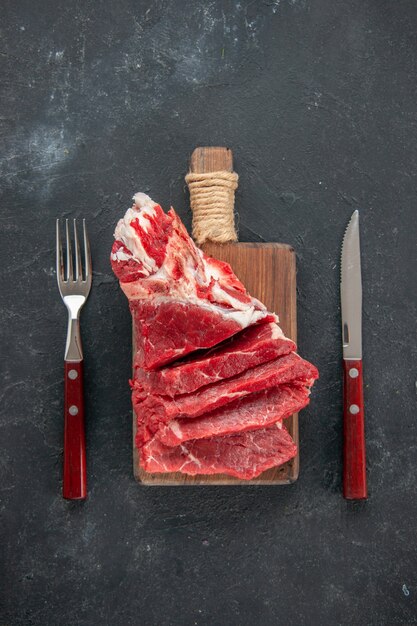 top view sliced fresh meat with fork and knife. meat food color meal