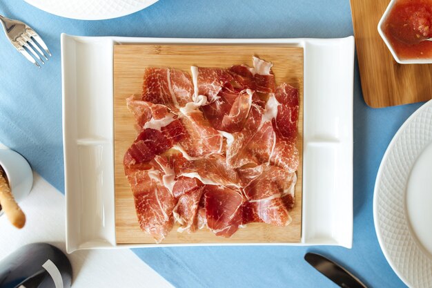 Top view on sliced jamon meat on the restaurant table