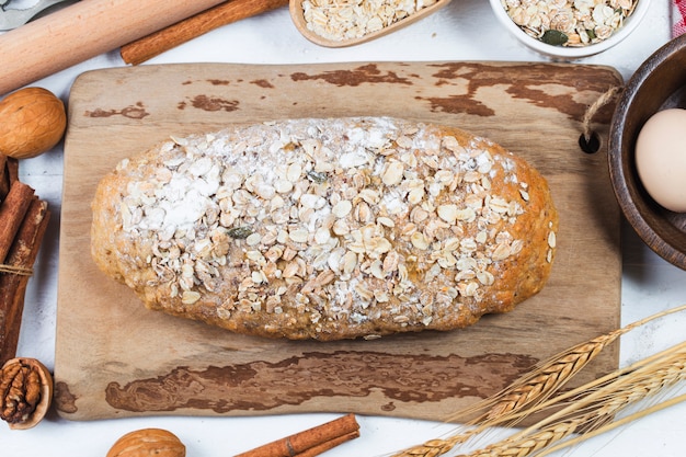 Top view of sliced wholegrain bread on a wooden cutting board.