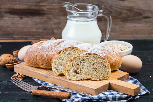 Top view of sliced wholegrain bread on a wooden cutting board.