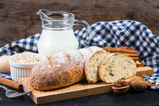 Top view of sliced wholegrain bread on a wooden cutting board.