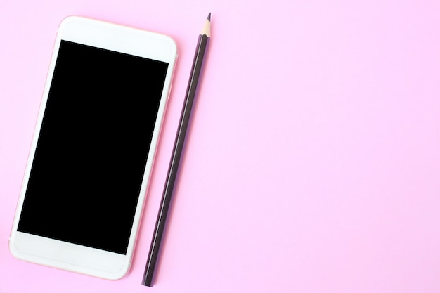 Top view smartphone and crayon on pink floor and have copy space.