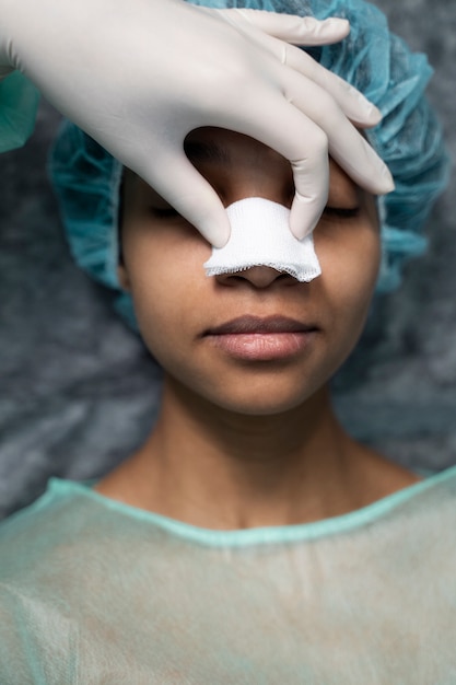 Photo top view smiley doctor with nose bandage