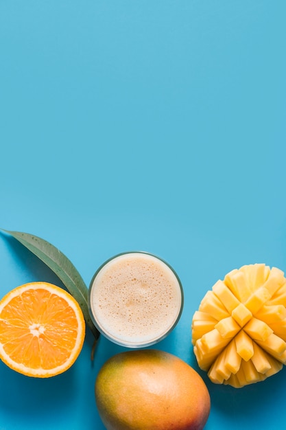 Top view smoothie with mango and orange with copy-space