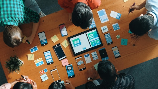 top view of software developer team looking ux design from tablet convocation
