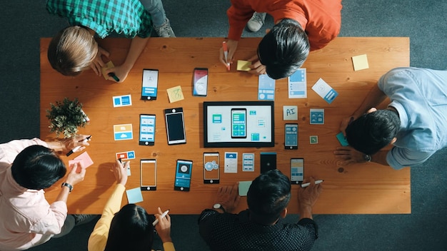 top view of software developer team looking ux design from tablet convocation