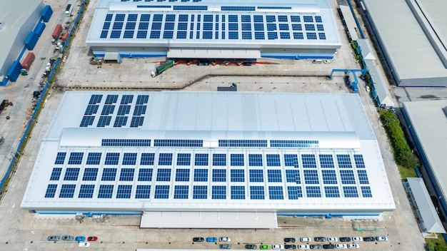 Top view Solar Cell on Warehouse Factory Solor photo voltaic panels system power or Solar Cell on industrial building roof for producing green ecological electricity Production of renewable energy