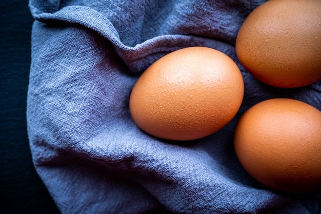 Top view of some fresh eggs on a dark background Concept of healthy and natural food.