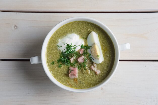 Top view of soup-puree with han and egg.