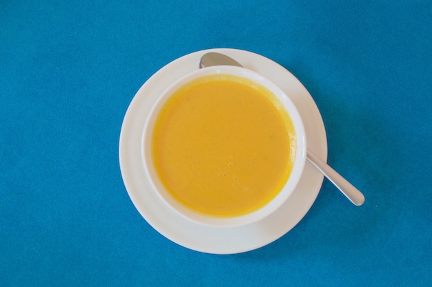 Top view of soup served in a white bowl and plate