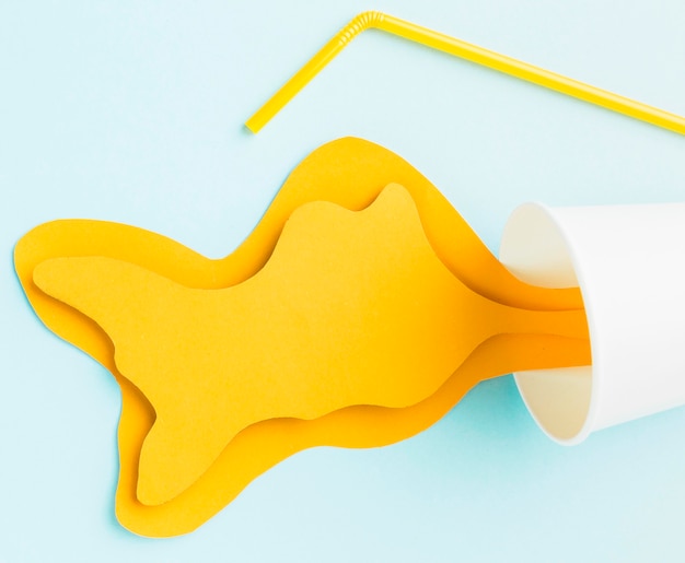 Top view of spilled paper juice with straw