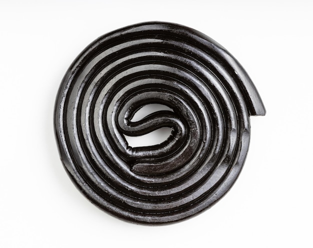 Top view of spiral from liquorice candy on white