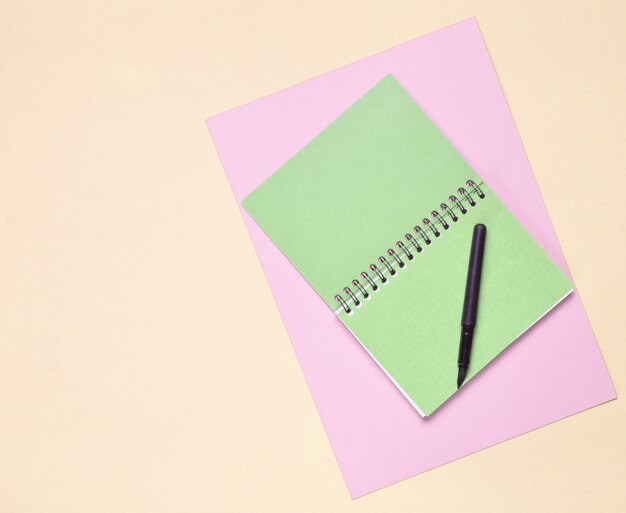 Top view of spiral notebook with pen