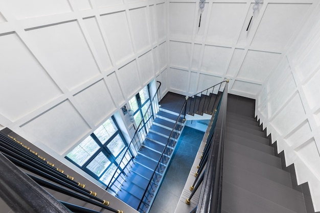 Top view of the staircase the steps of which are made of natural stone marble and granite white