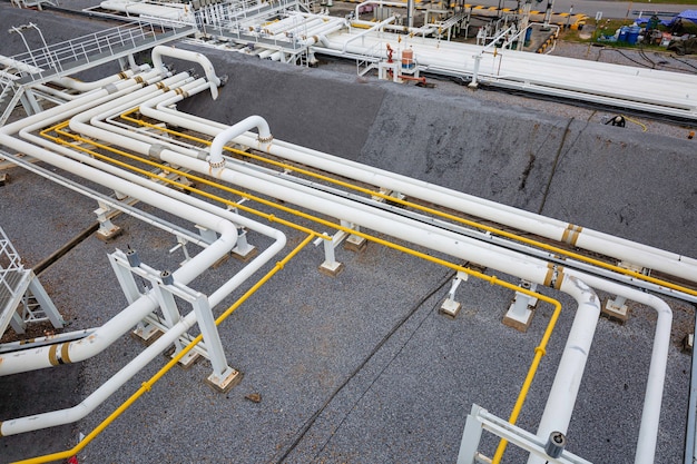 Top view steel long pipes and valves factory during refinery Petrochemistry industry in gas and oil site distillery