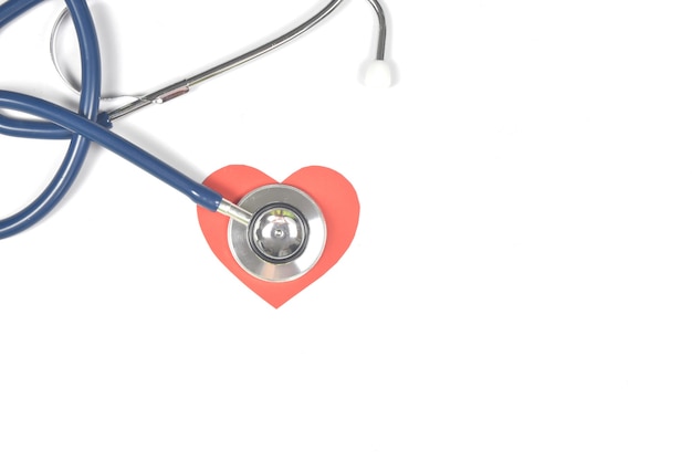 Photo top view of stethoscope and heart shape on white background with copy space