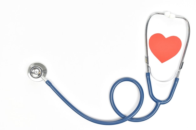 Photo top view of stethoscope and heart shape on white background with copy space