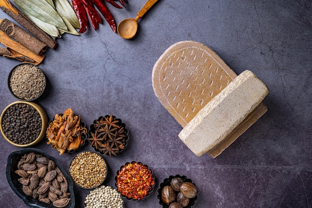 Top view of a stone board and Indian seasonings on a table