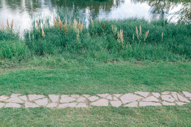 Top view of the stone road on the shore of the pond