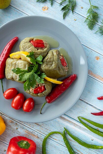 Top view of stuffed peppers on blue wooden background