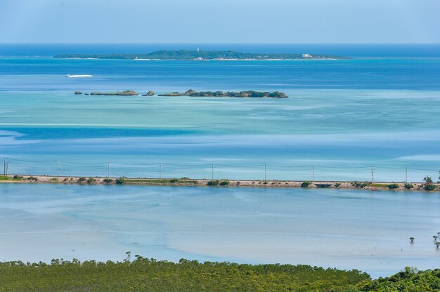 Top view of stunning blue tones sea Main road between sea and river Hatoma island on background