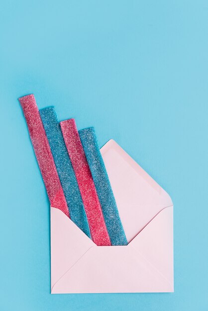 Top view of sugar stripes sticking out from an envelope