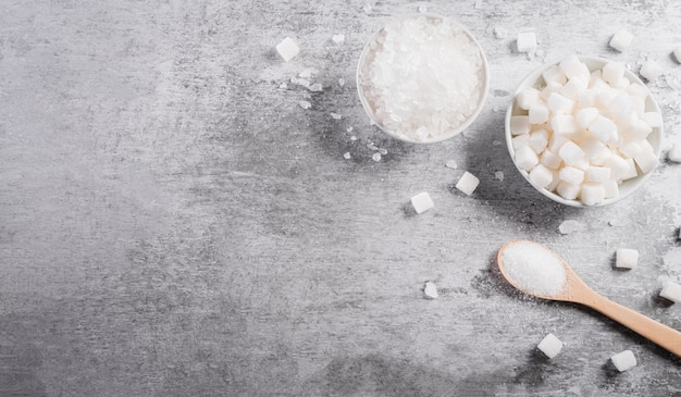 Top view of sugars in a bowl and spoon a symbol of diabetic control in the blood