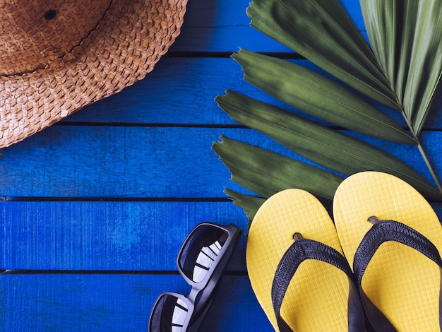 Top view of Summer accessories on blue wooden floor