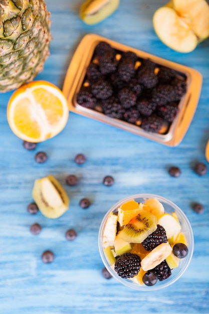 Top view of summer delicious desert. Bowl full of delicious fruits