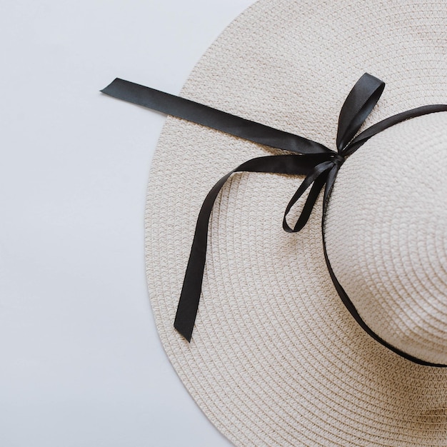 Top view of summer hat with black ribbon isolated on white background with copy space