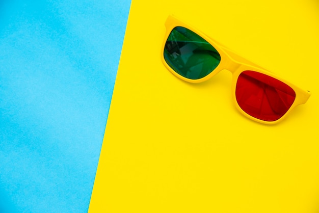 Top view for sunglasses on a colorful background.