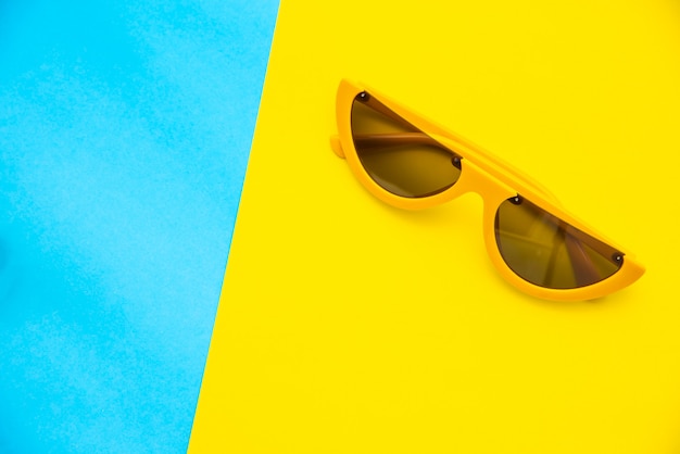 top view for sunglasses on a colorful background.