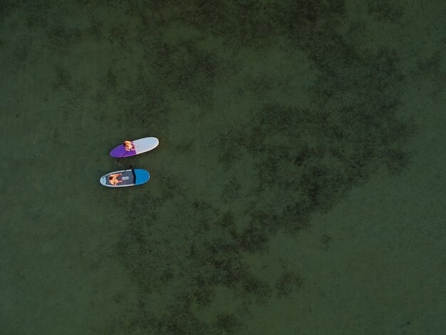 Top view of SUP boards on shallow turquoise water of Azov sea, Ukraine