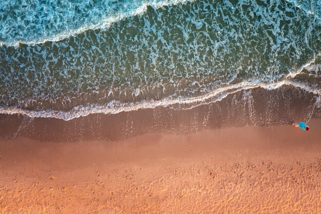 Top view of the surf lie Waves and sandy beach Artistic redgreen gradient color