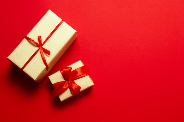 Top view of surprise gifts with red silk ribbons