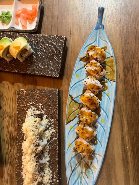 top view of a sushi plate with variety of maki rolls ready to eat